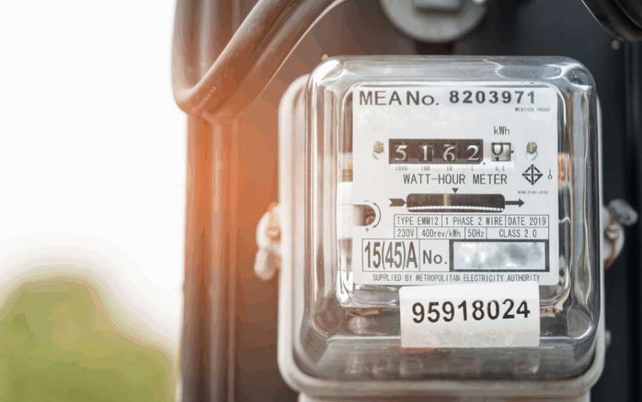 Close-up of a watt-hour meter displaying electricity usage measurements and serial numbers.